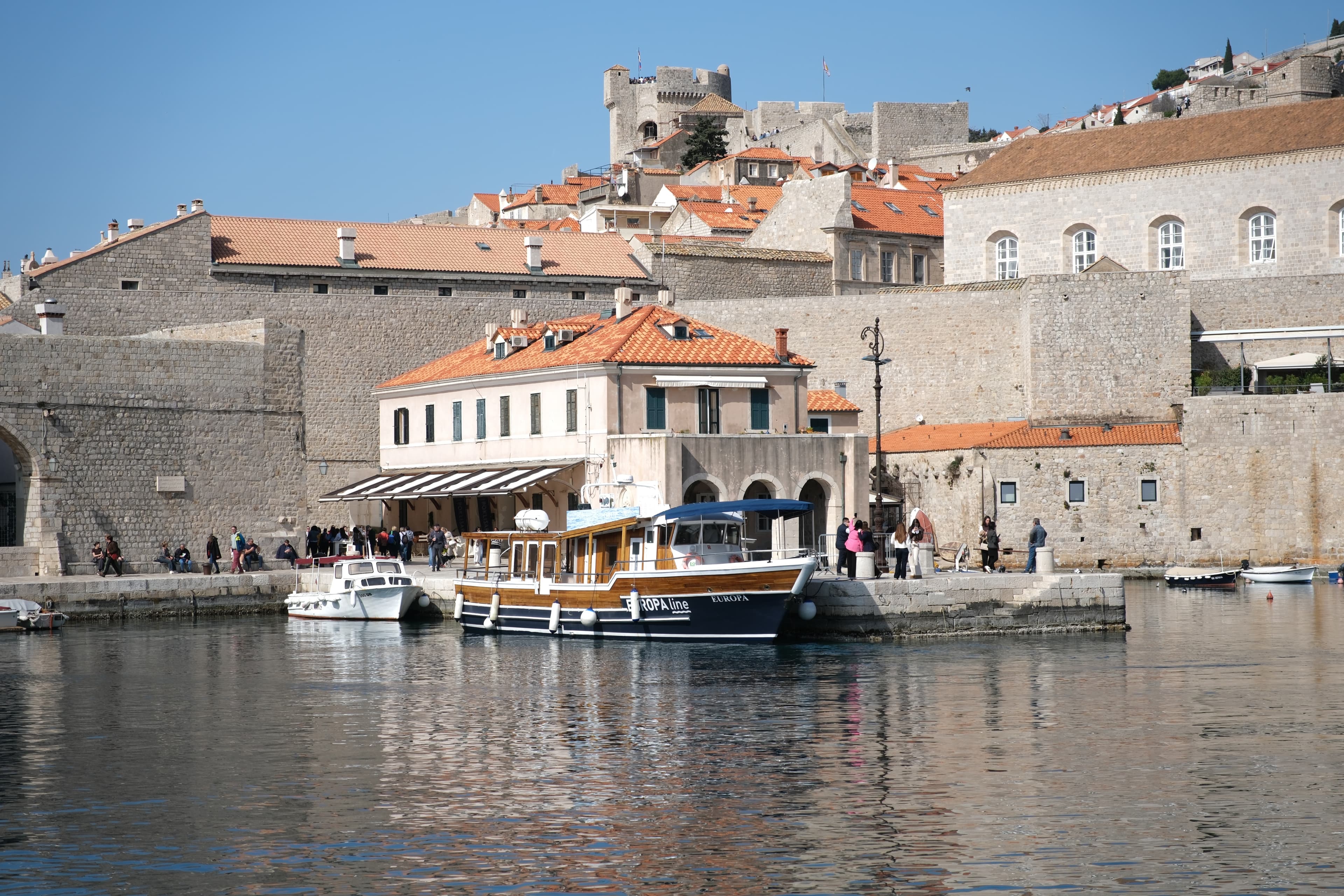 Boats resting along Dubrovnik's historic waterfront.